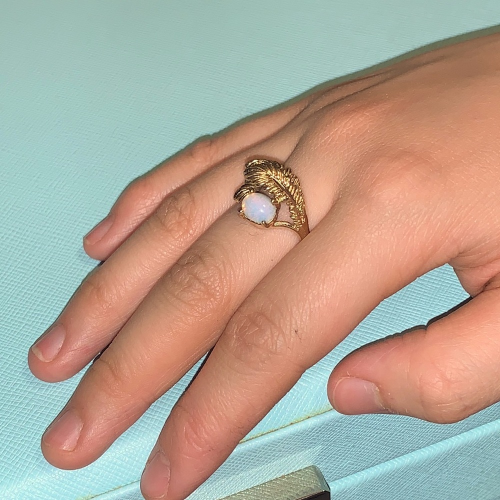 Cosmetic gold tone feathers & faux moonstone ring